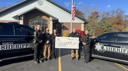 AAACU Team member presents a check to a member of the Cheboygan High School Senior Class of 2025